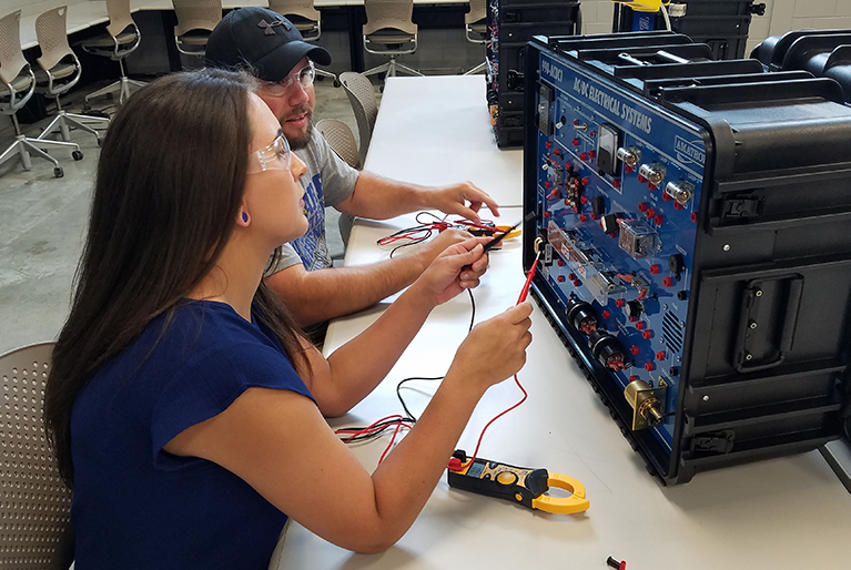 Male and Female Student Working on Electrical Panel