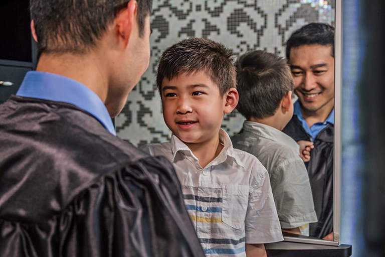 Father graduate with his young son