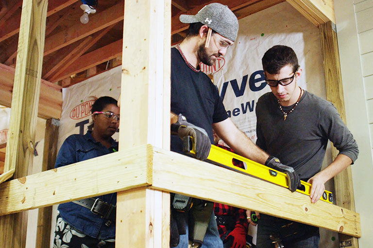 2 students checking a level on a construction project