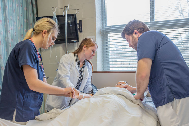 Medical students practicing on manakin. 